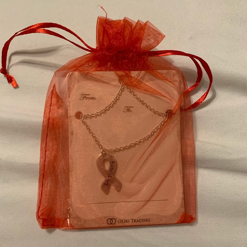 New in little gift baggie Breast Cancer Ribbon Necklace that says “be strong”